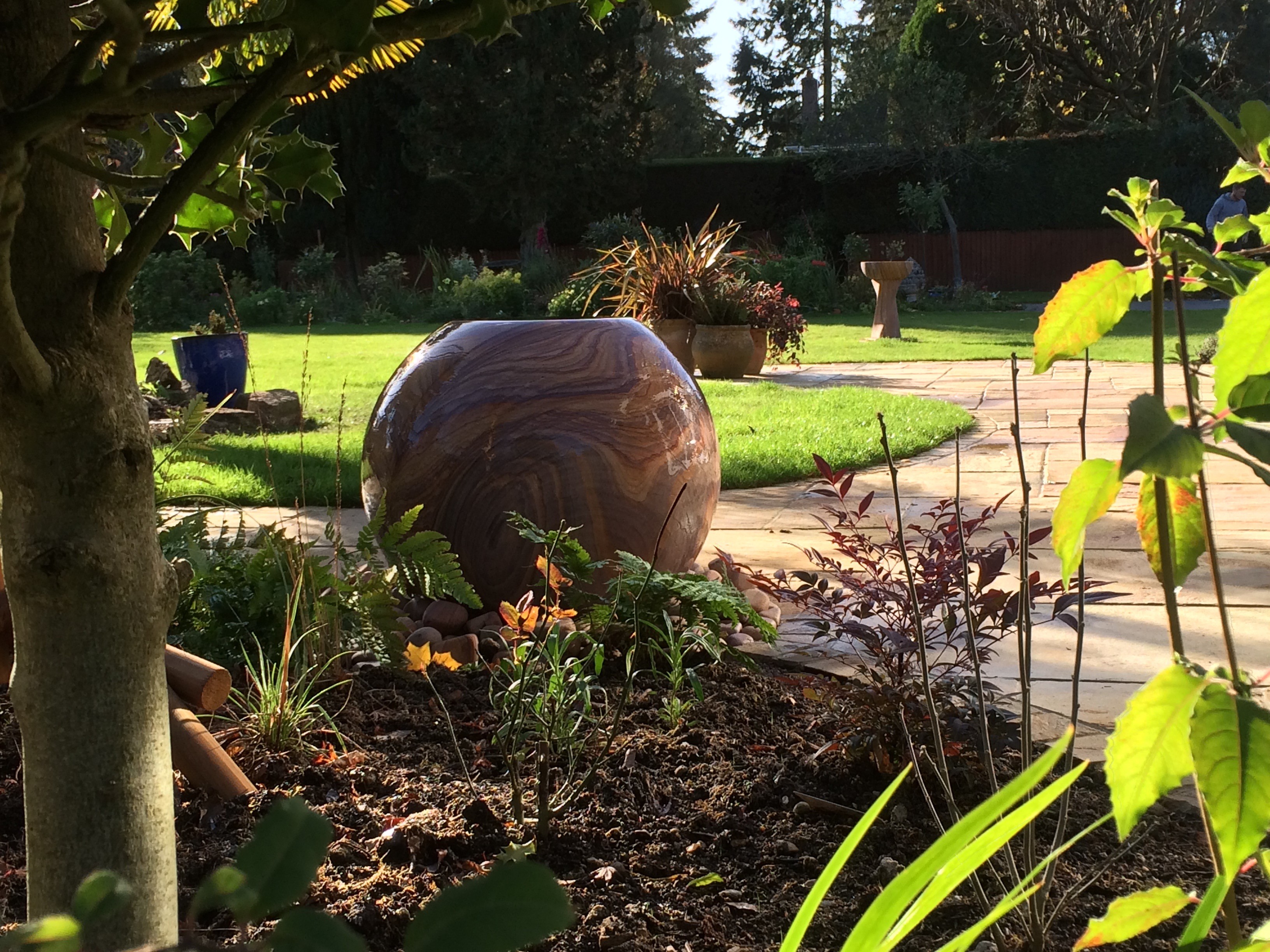Photo of rows of books in a library with marble busts.
